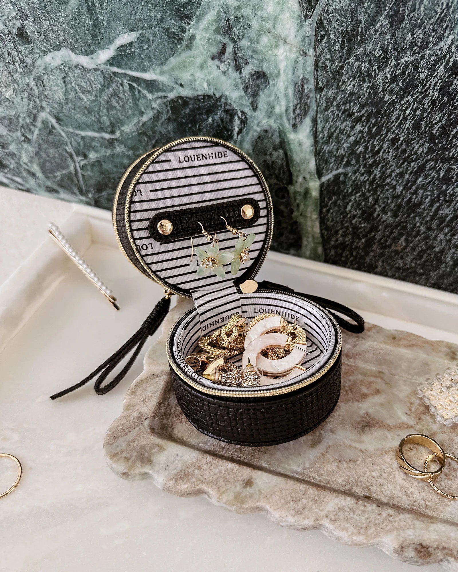 The Louenhide Sofia Jewelry Box is designed to hold and protect your most treasured pieces. Featuring a compact silhouette with two protective compartments, this multi-zipper case offers a streamlined way to store your jewellery without taking up unnecessary space. This travel jewellery case is the perfect addition to your bag, ensuring valuables stay secure and organised wherever the day leads.