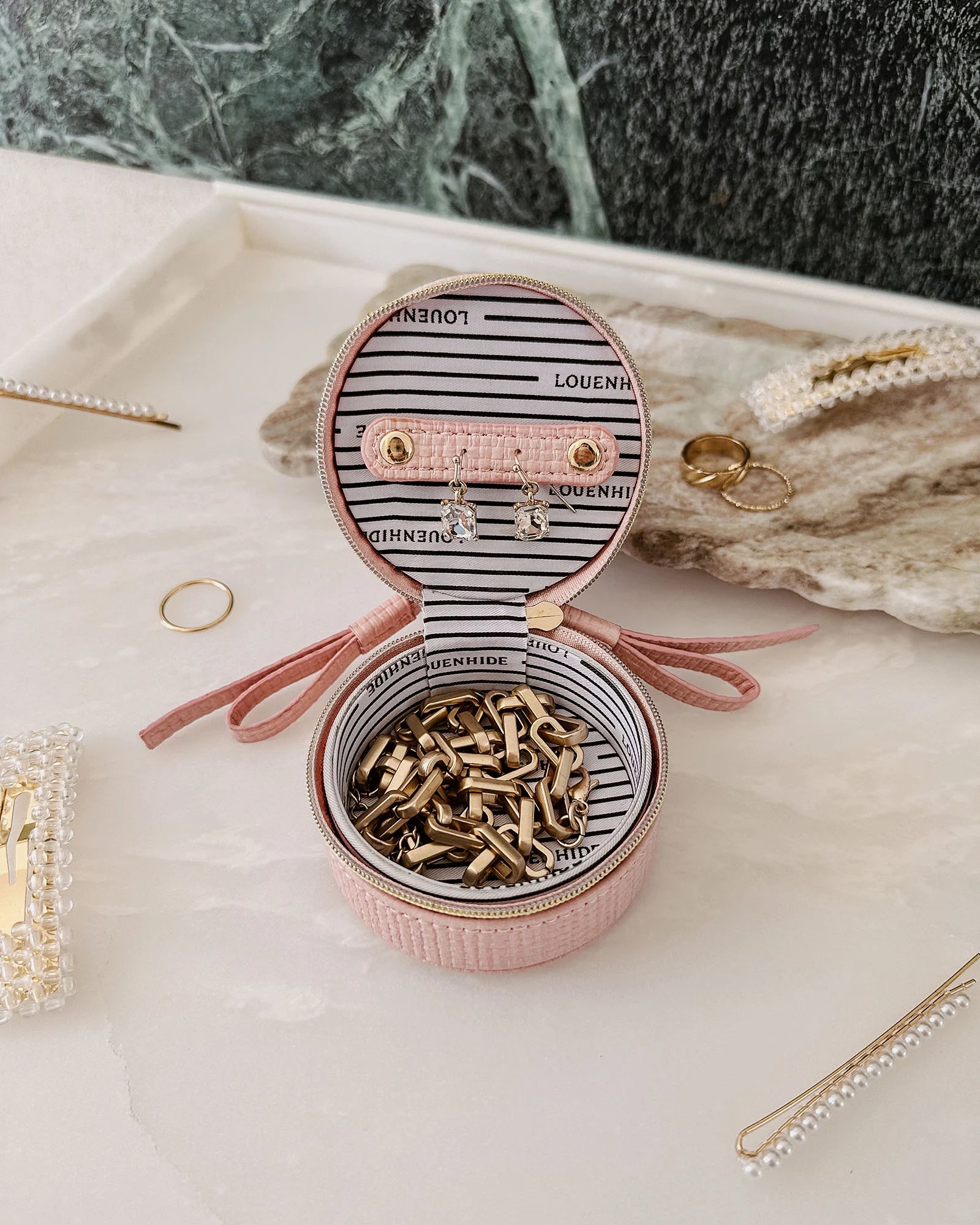 The Louenhide Sofia Jewelry Box is designed to hold and protect your most treasured pieces. Featuring a compact silhouette with two protective compartments, this multi-zipper case offers a streamlined way to store your jewellery without taking up unnecessary space. This travel jewellery case is the perfect addition to your bag, ensuring valuables stay secure and organised wherever the day leads.
