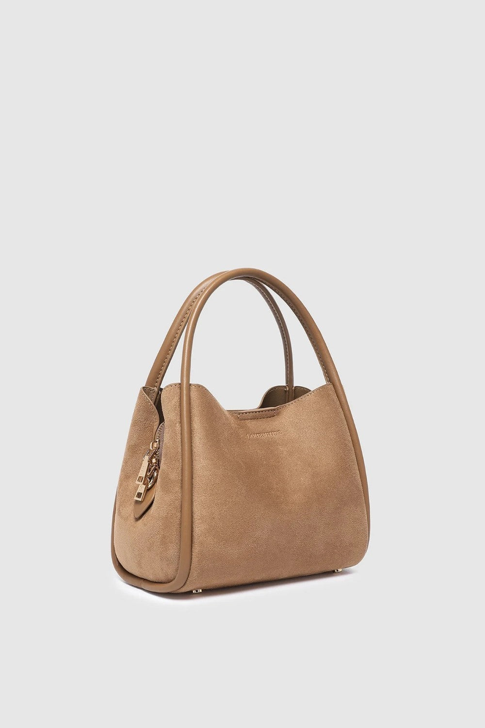 A tan suede shoulder bag with double top handles and a gold-tone zipper pull, shown from a three-quarter angle on a light gray background.