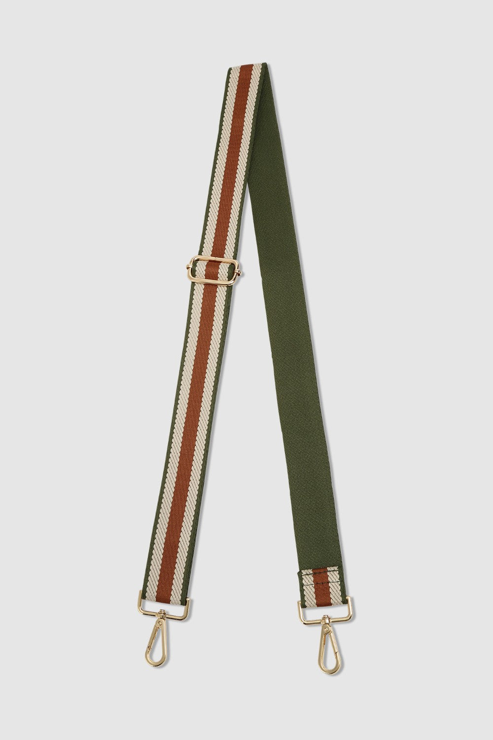 Green and tan striped bag strap on a light gray background