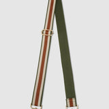 Green and tan striped bag strap on a light gray background