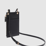 Black crossbody bag with a strap on a light gray background