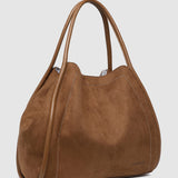 Brown pleather handbag on a light gray background