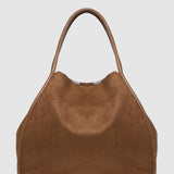 Brown suede handbag on a light gray background
