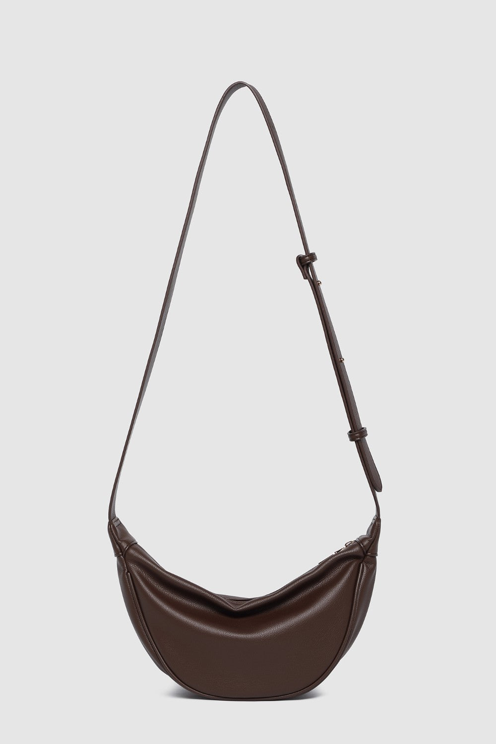 Brown shoulder bag with a strap on a light gray background