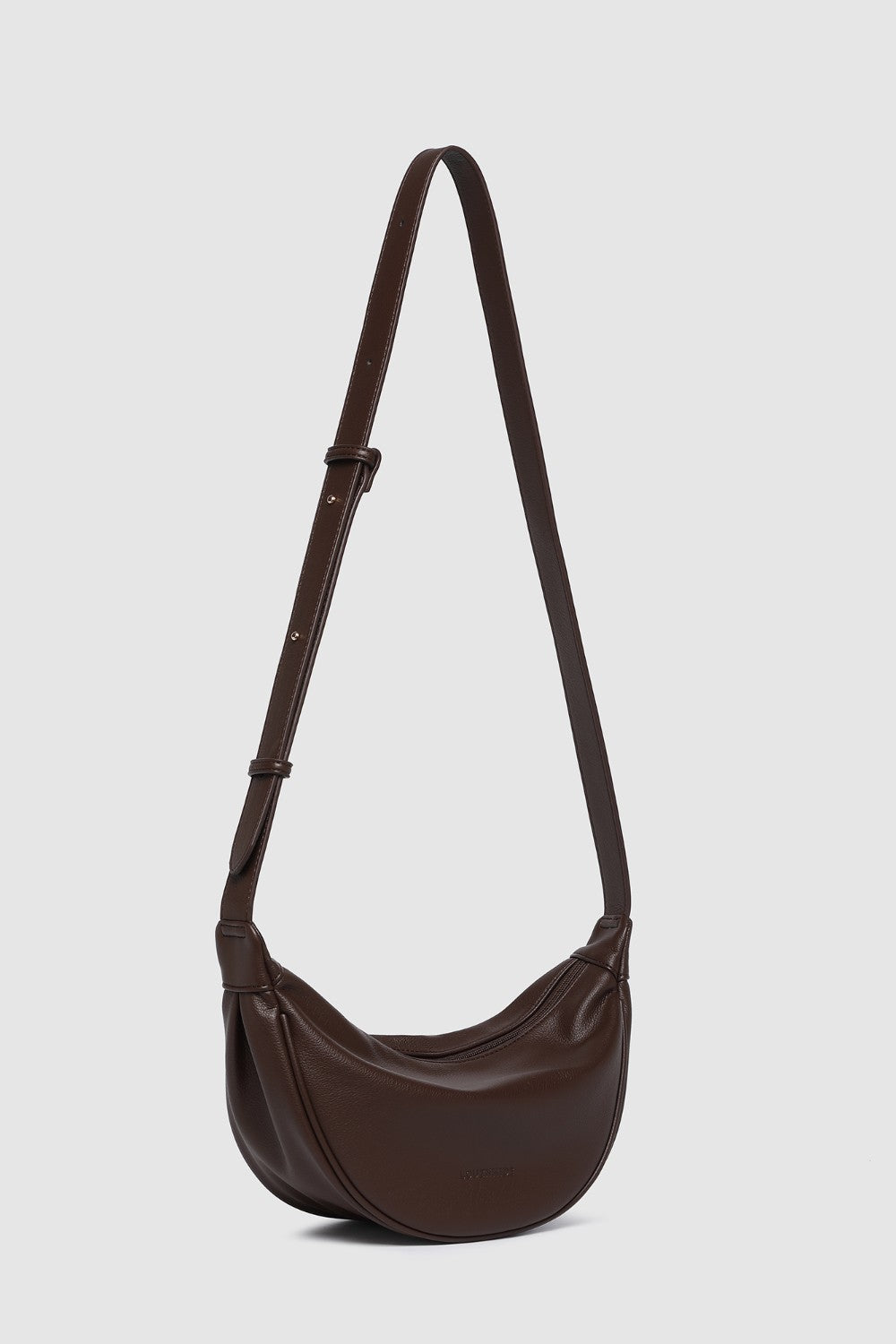 Brown pleather shoulder bag on a light gray background