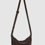 Brown pleather shoulder bag on a light gray background