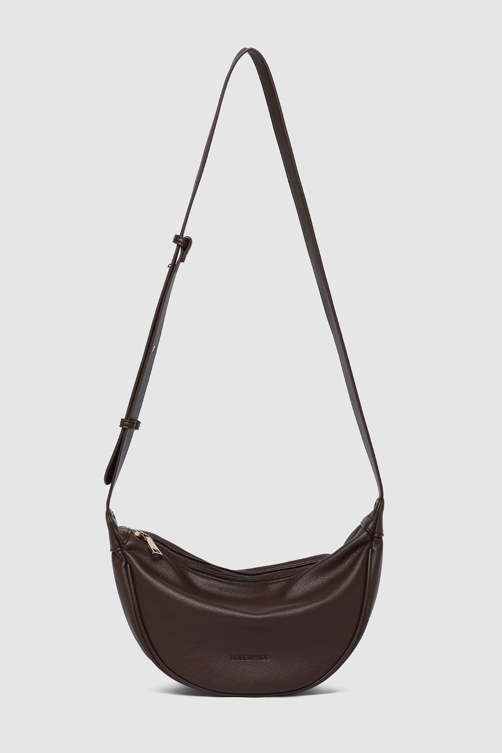 Brown shoulder bag with a strap on a light gray background