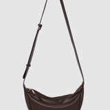 Brown shoulder bag with a strap on a light gray background