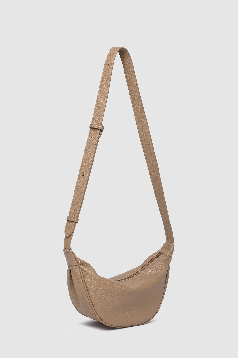 Beige shoulder bag with a strap on a light gray background