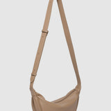 Beige shoulder bag with a strap on a light gray background
