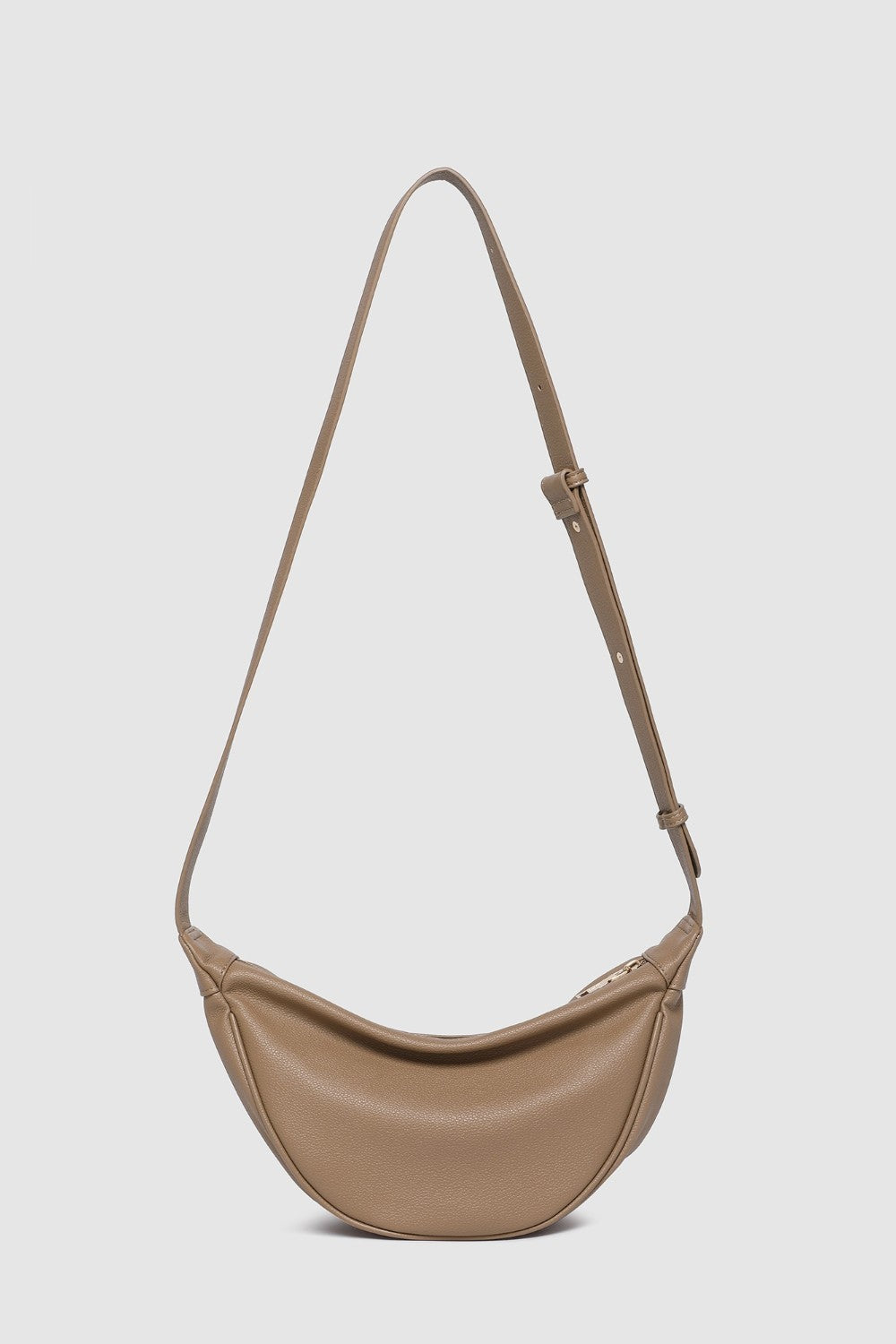 Beige shoulder bag with a strap on a light gray background