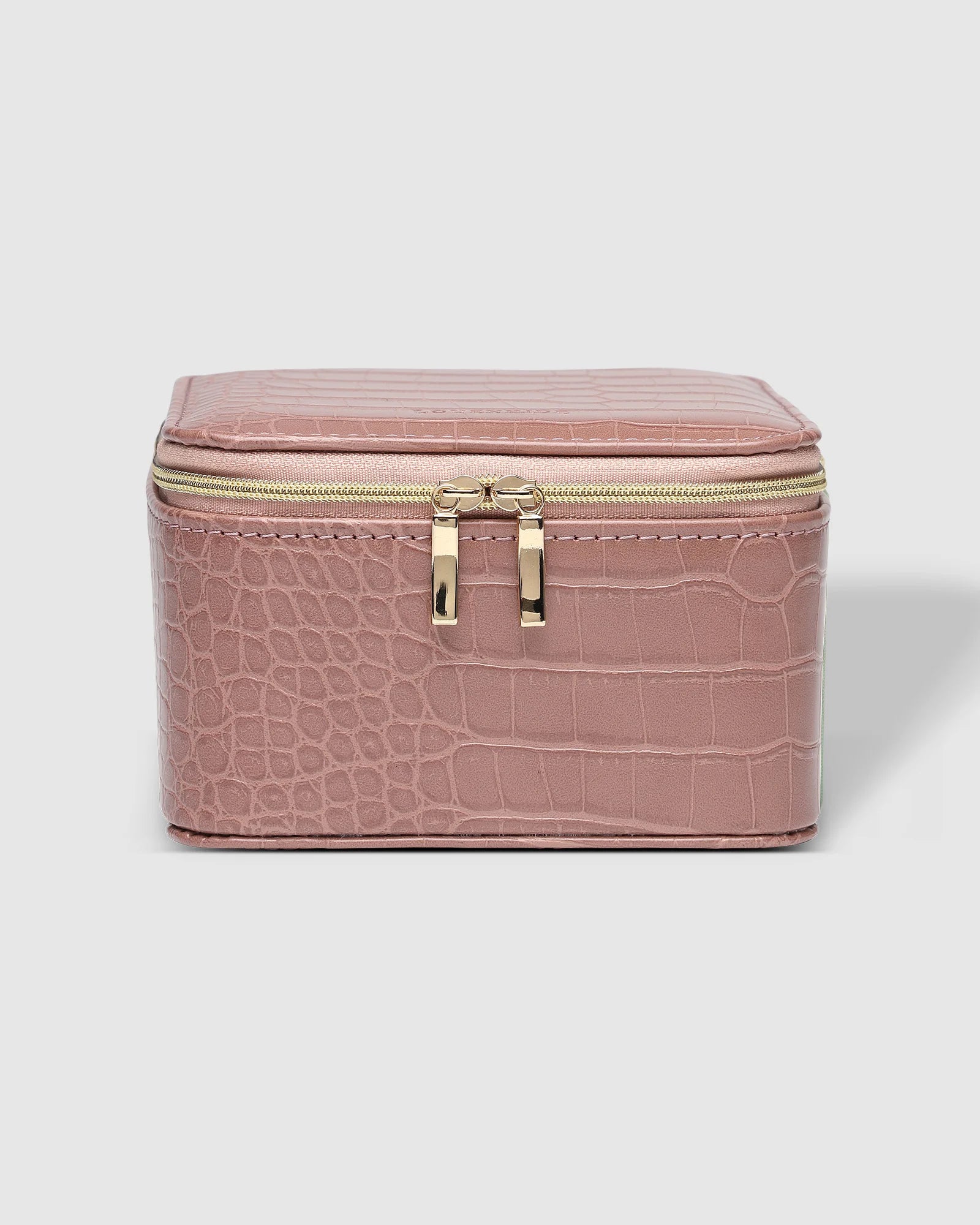 The Louenhide Tara Croc Jewelry Box is a large, square jewellery box designed to keep your bespoke pieces safe and secure at home or when you are on the go. Featuring a croc-like vegan leather exterior, this women's jewellery box boasts ample space with its two large compartments, one elastic slip pocket and four ring rolls. Fit all your favourite jewels, including rings, necklaces and bracelets inside. You'll also love the removable tray revealing enough room for larger statement pieces.