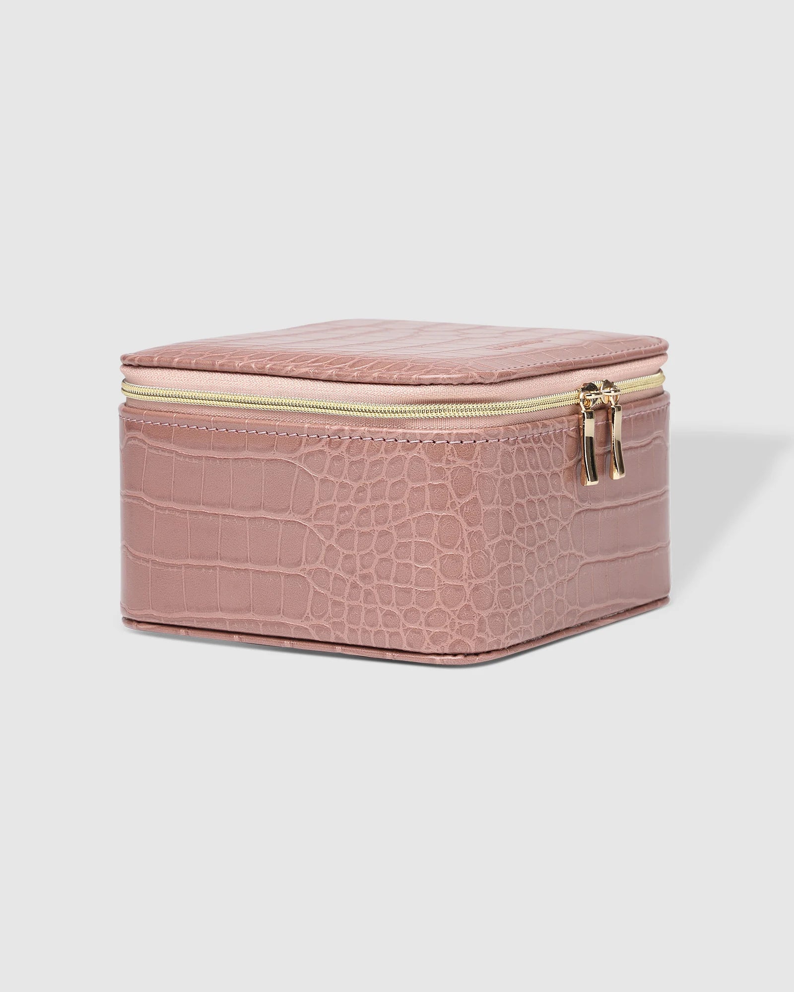 The Louenhide Tara Croc Jewelry Box is a large, square jewellery box designed to keep your bespoke pieces safe and secure at home or when you are on the go. Featuring a croc-like vegan leather exterior, this women's jewellery box boasts ample space with its two large compartments, one elastic slip pocket and four ring rolls. Fit all your favourite jewels, including rings, necklaces and bracelets inside. You'll also love the removable tray revealing enough room for larger statement pieces.