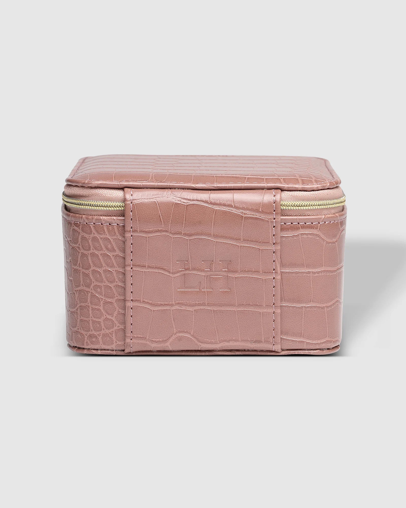 The Louenhide Tara Croc Jewelry Box is a large, square jewellery box designed to keep your bespoke pieces safe and secure at home or when you are on the go. Featuring a croc-like vegan leather exterior, this women's jewellery box boasts ample space with its two large compartments, one elastic slip pocket and four ring rolls. Fit all your favourite jewels, including rings, necklaces and bracelets inside. You'll also love the removable tray revealing enough room for larger statement pieces.