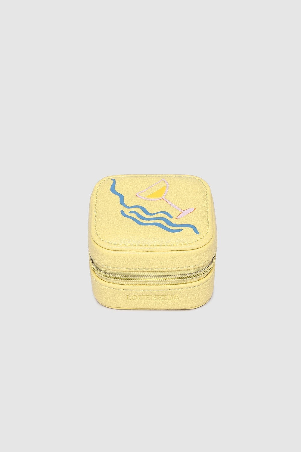 Yellow jewelry box with a design on a light gray background