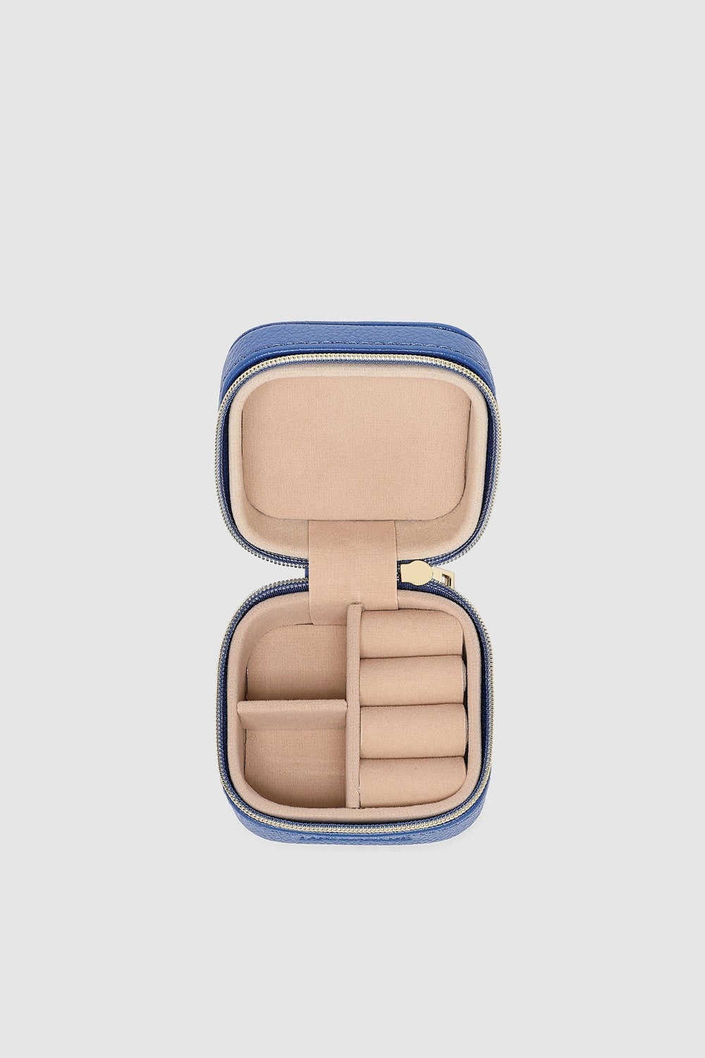 Open jewelry case with beige interior on a light gray background