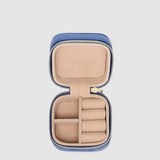 Open jewelry case with beige interior on a light gray background