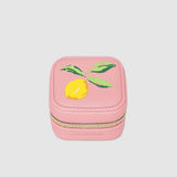 Pink jewelry box with a lemon design on a light gray background
