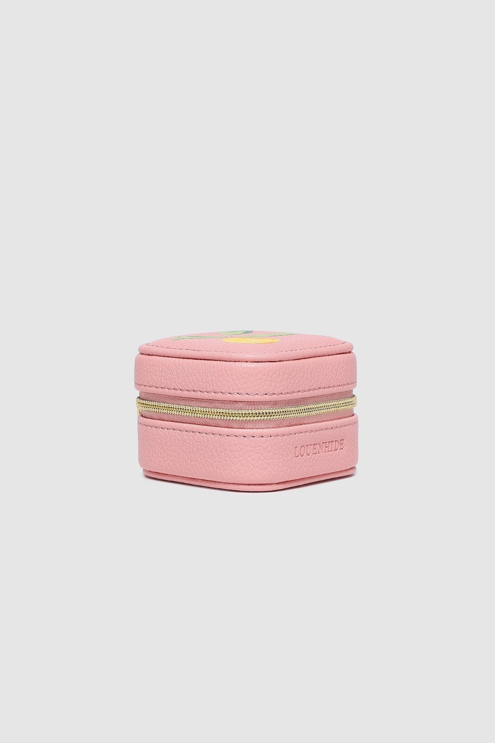 Pink jewelry box with gold zipper on a light gray background