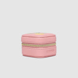 Pink jewelry box with gold zipper on a light gray background