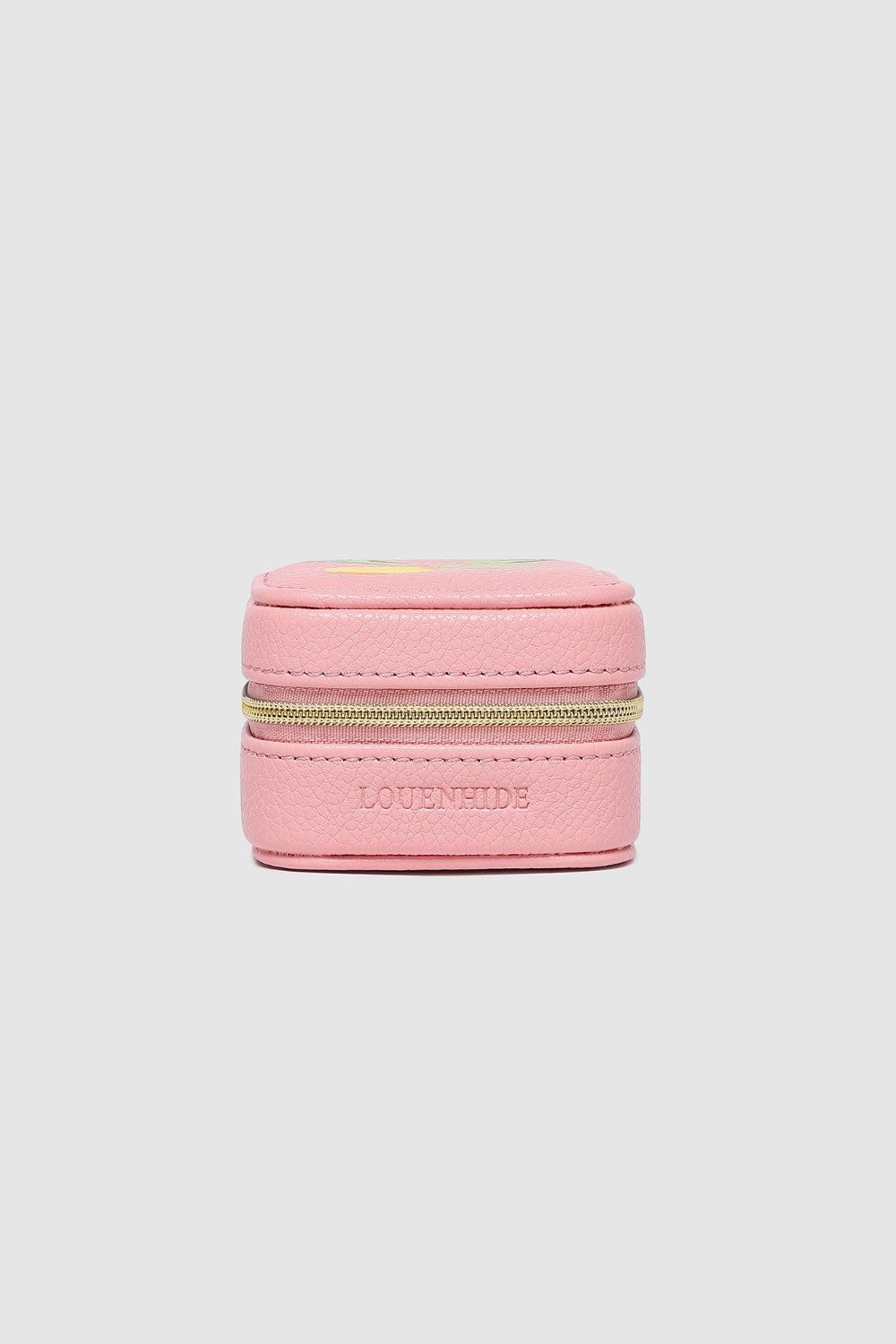 Pink jewelry box with gold zipper on a light pink background