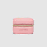 Pink jewelry box with gold zipper on a light pink background