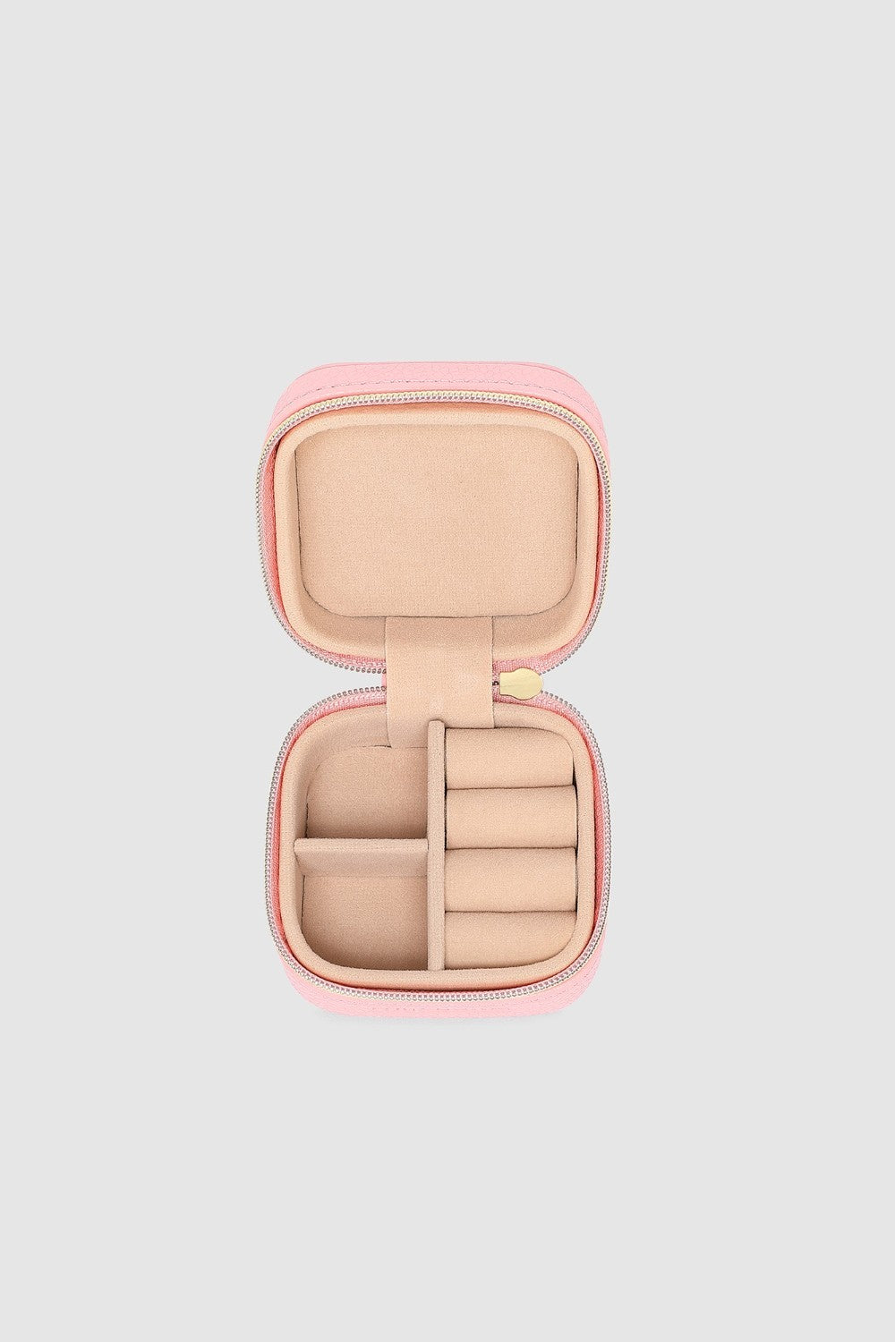 Pink jewelry case with open lid on a light gray background