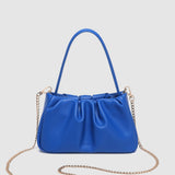 Blue handbag with a chain detail on a light gray background