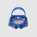 Blue handbag with striped lining on a light gray background