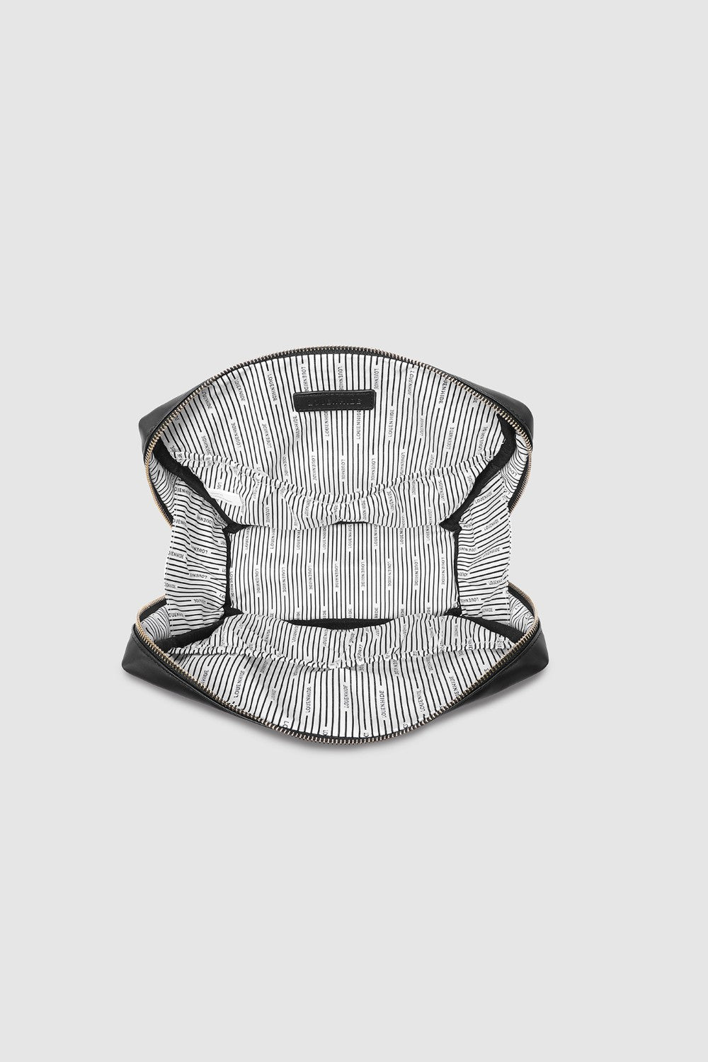 Black bag with white patterned lining on a light gray background