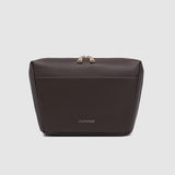 Brown pleather bag with gold zipper on a light gray background