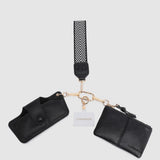 Black pleather wallet with strap and cardholder on a light gray background