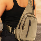 The Louenhide Boyd Nylon Sling Bag is an on-trend unisex sling bag designed with both style and functionality in mind. Organisation has never been easier with the three-section design, your valuables are within easy reach and secured safely with the stylish gunmetal zippers. Whether you're chasing an urban aesthetic or embodying an off-duty street style, this unisex nylon sling bag adapts to any casual outfit, enhancing your personal style while still offering ultimate practicality. The Boyd Khaki features 