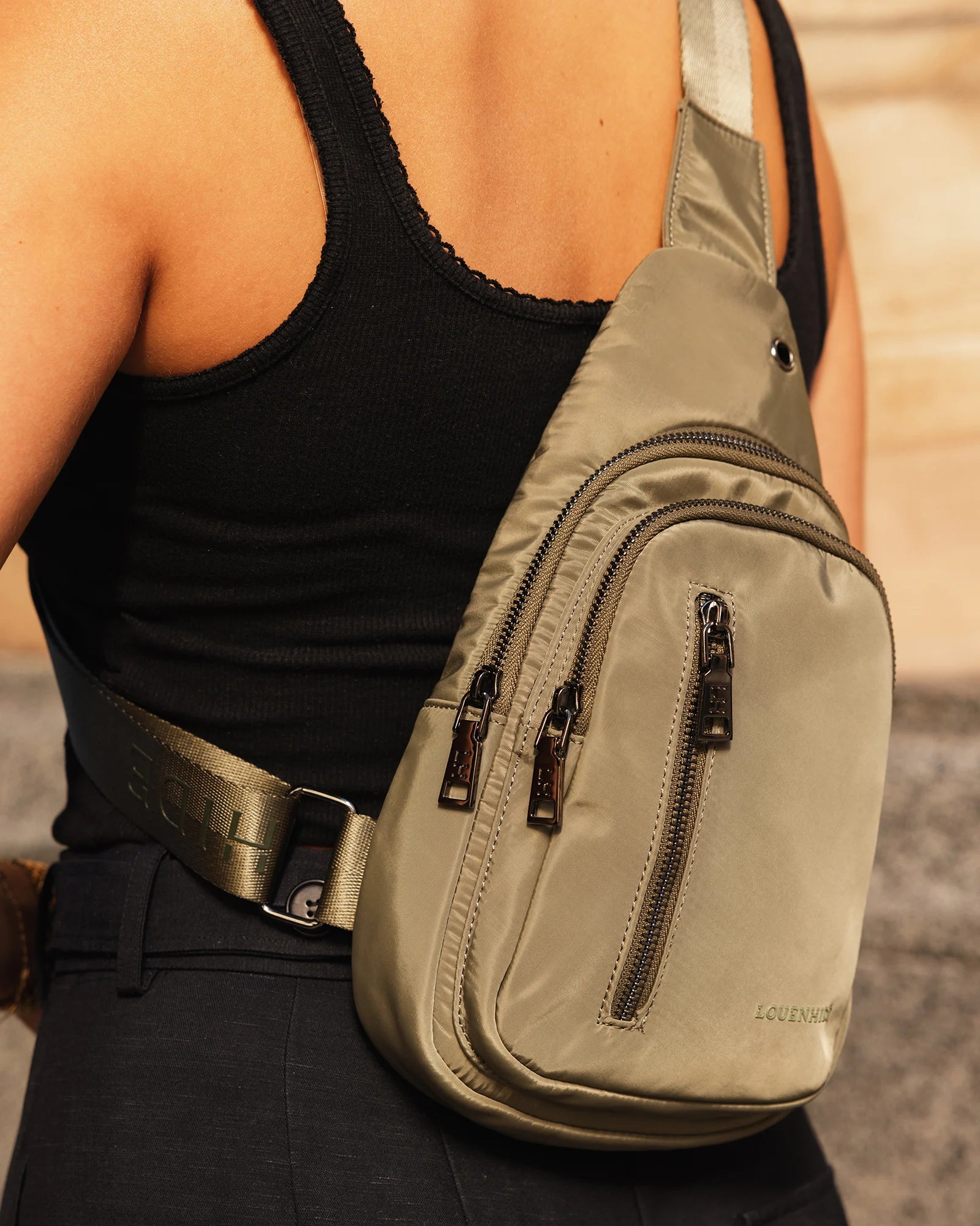 The Louenhide Boyd Nylon Sling Bag is an on-trend unisex sling bag designed with both style and functionality in mind. Organisation has never been easier with the three-section design, your valuables are within easy reach and secured safely with the stylish gunmetal zippers. Whether you're chasing an urban aesthetic or embodying an off-duty street style, this unisex nylon sling bag adapts to any casual outfit, enhancing your personal style while still offering ultimate practicality. The Boyd Khaki features 