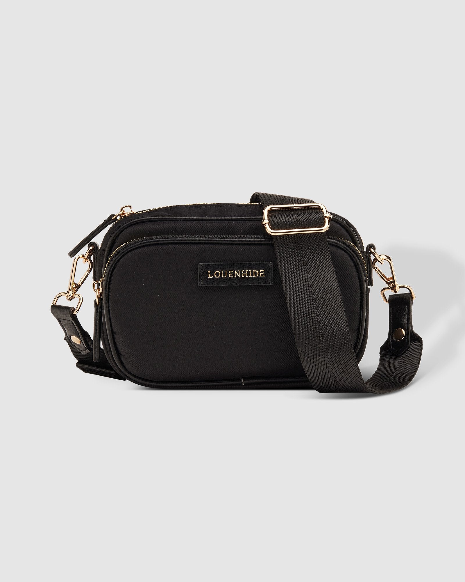 The Louenhide Cali Nylon Crossbody Bag is designed for comfort and convenience. The adjustable and detachable sateen guitar strap allows for comfortable wear crossbody or over the shoulder. The bag features one zip pocket and one slip pocket in the main compartment, as well as a front zip pocket for easy access to essentials. The secure zip closure keeps your belongings safe and secure.