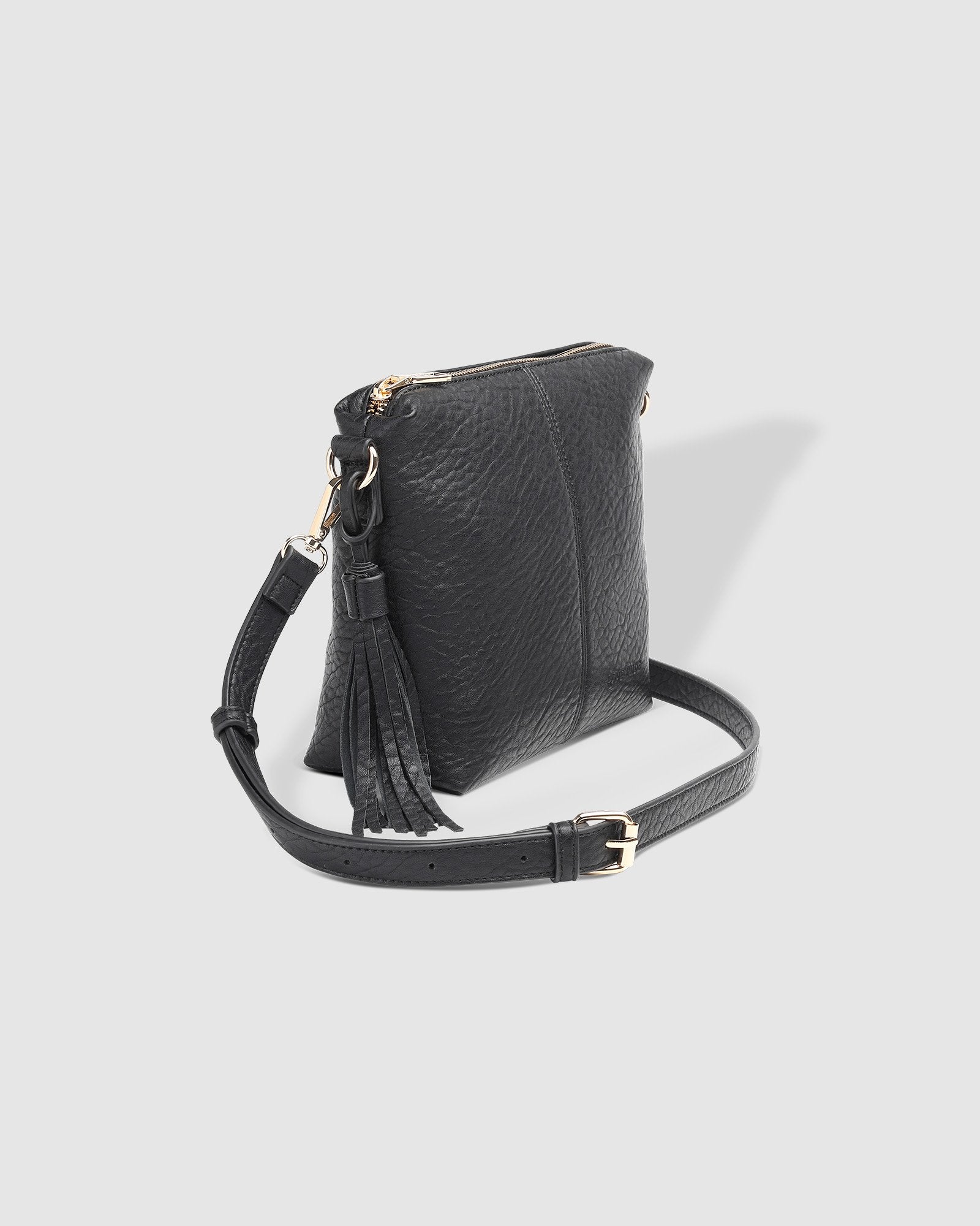 The Louenhide Kasey Textured Crossbody Bag with the Logo Strap is a classic women's everyday bag with elevated style. Designed in a soft and slouchy design, this casual crossbody bag is a smaller take on our best-selling Daisy Crossbody Bag. Secure your favourite products in either the zip pocket, the two slip pockets or in the interior compartment for your bigger items such as sunglasses, purse and phone with ease.