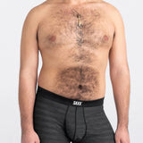 Man wearing black SAXX underwear on a white background