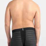 Person wearing black boxer briefs on a plain background