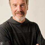 Man wearing a dark gray sweater against a plain background