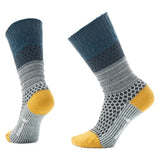 Pair of socks with green, gray, and yellow pattern on a white background