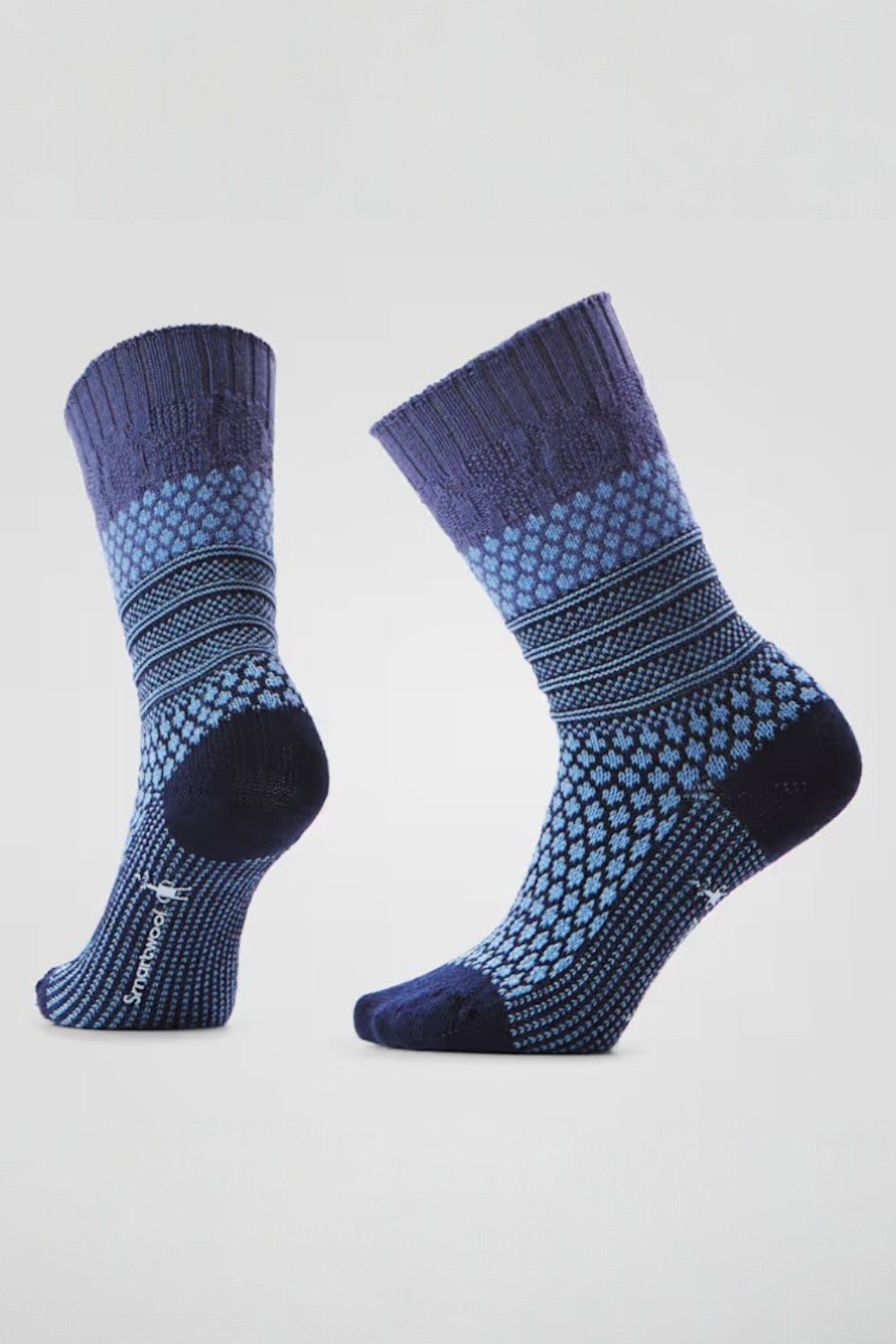 Pair of purple patterned socks on a light blue background