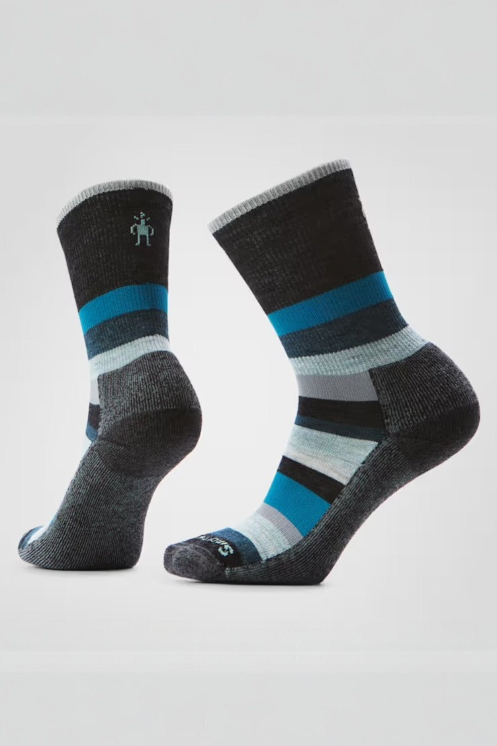 Pair of black socks with blue and gray stripes on a light gray background