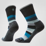 Pair of black socks with blue and gray stripes on a light gray background