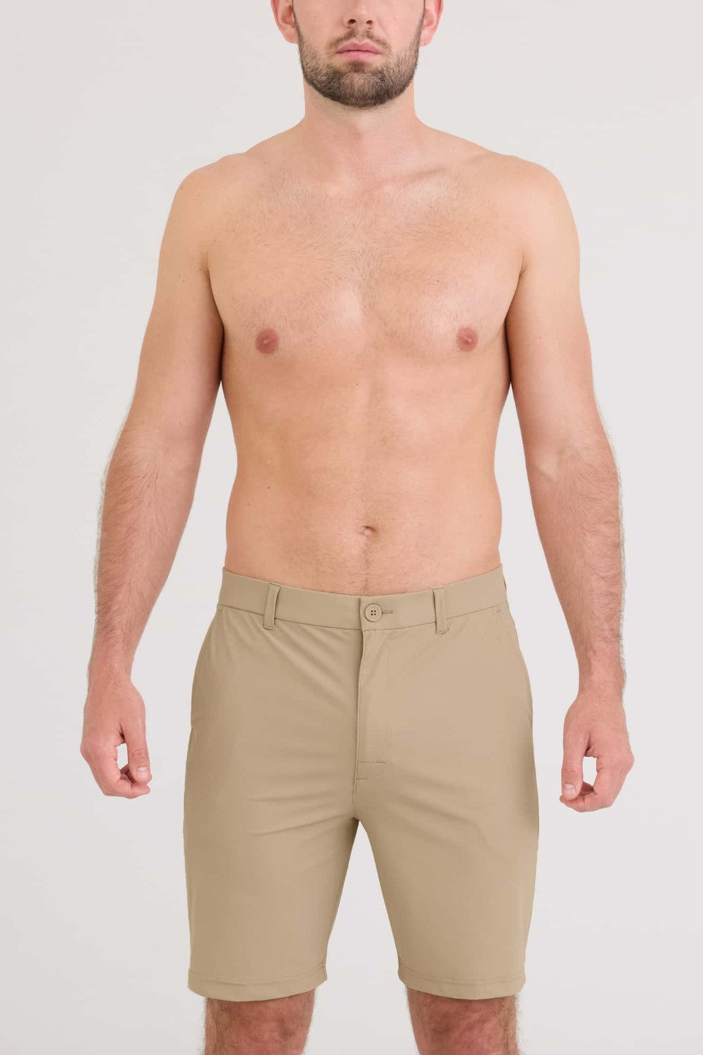 Man wearing beige shorts on a white background