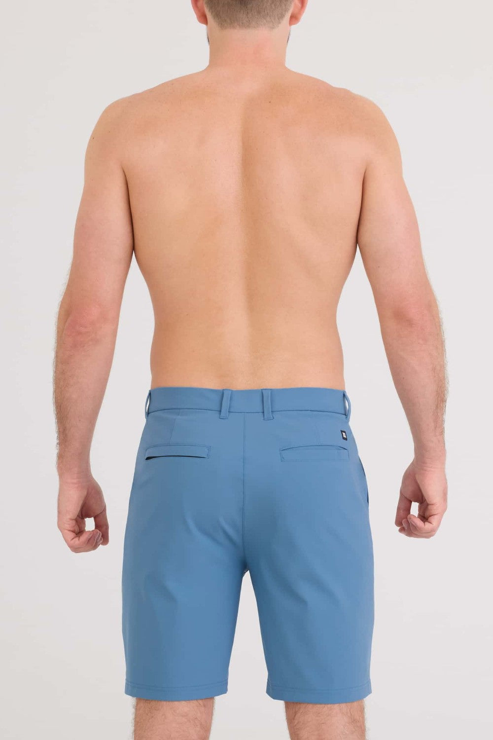 Man wearing blue shorts on a white background