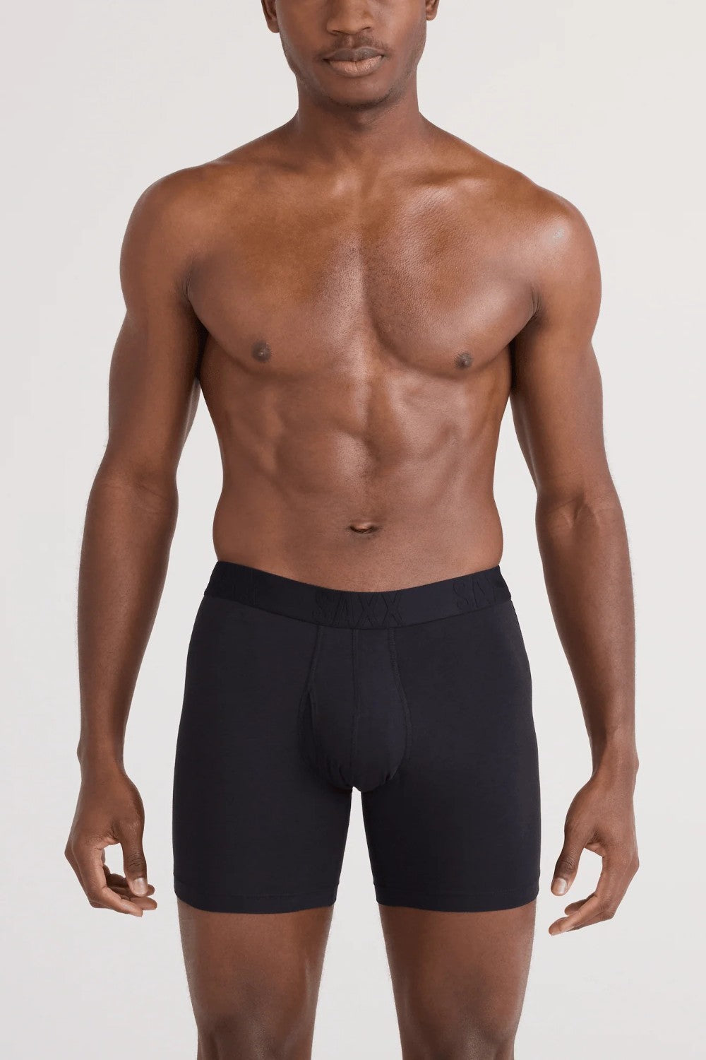 Man wearing black boxer briefs on a white background