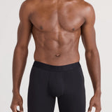 Man wearing black boxer briefs on a white background