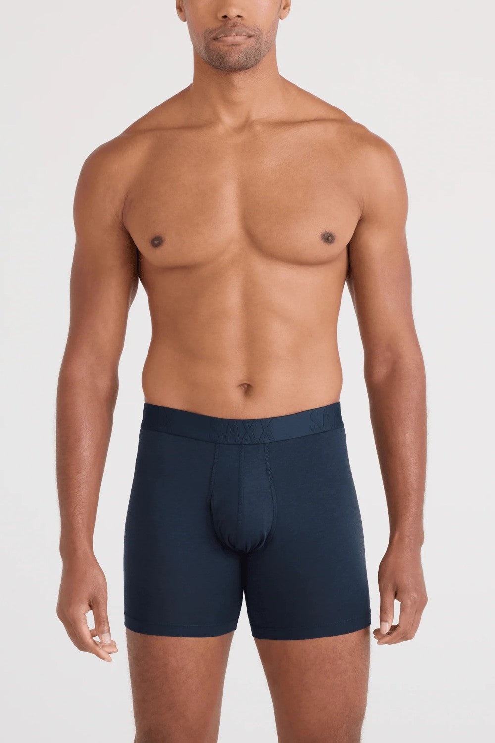 Man wearing navy blue boxer briefs on a white background