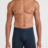 Man wearing navy blue boxer briefs on a white background
